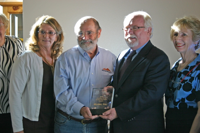Mintec chief operating officer Susan Wick and chairman Fred Banfield receive the 2012 Excellence in Global Business Award from Arizona congressman Ron Barber and Carolita Oliveros, vice chair of the Arizona District Export Council.